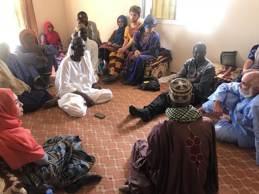 people sitting on the floor in a circle in Senegal