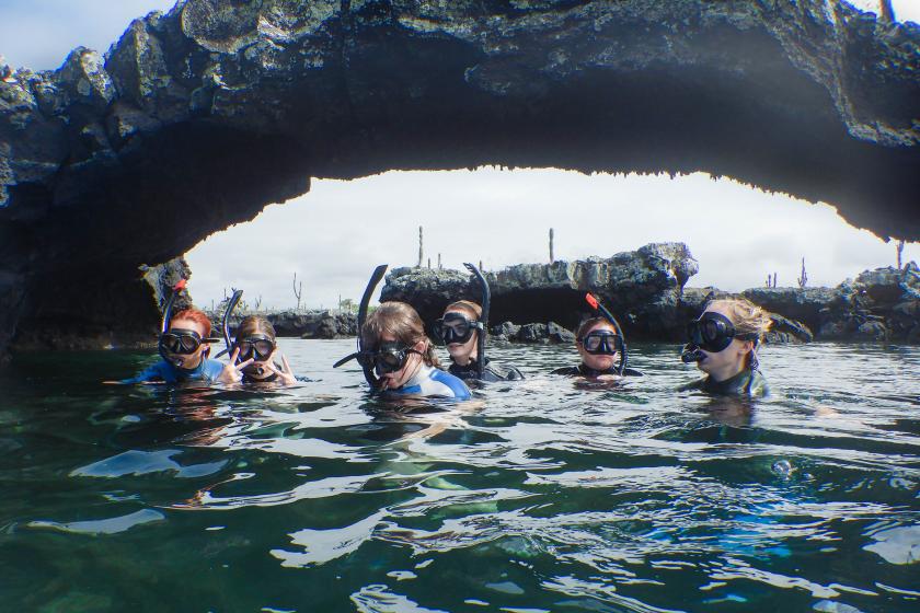 Students in the water snorkeling in Ecuador