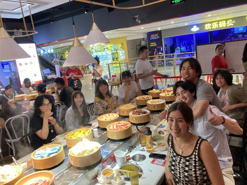 Group of students in China practicing eating hot pot